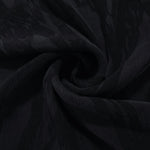 Swirl drape of black brushstroke leaf jacquard with tonal contrast and smooth movement.