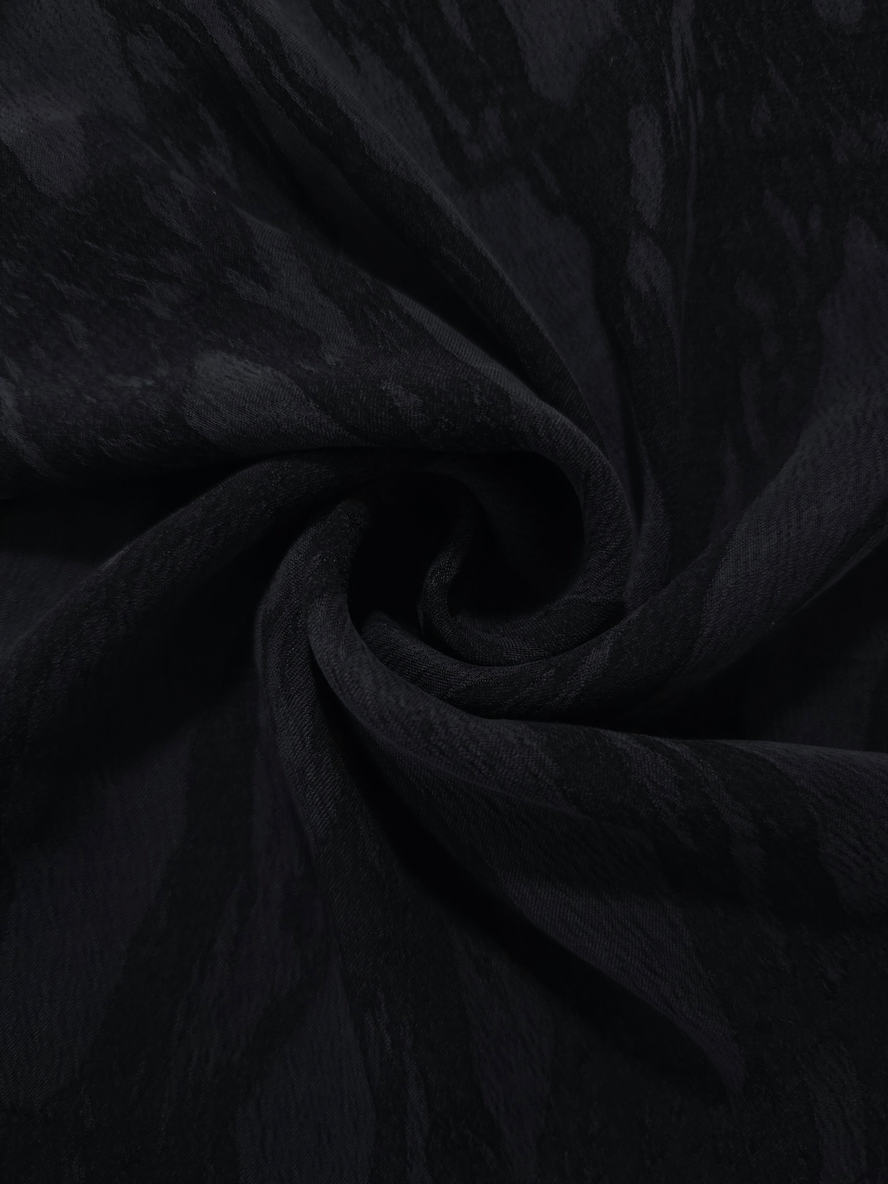 Swirl drape of black brushstroke leaf jacquard with tonal contrast and smooth movement.