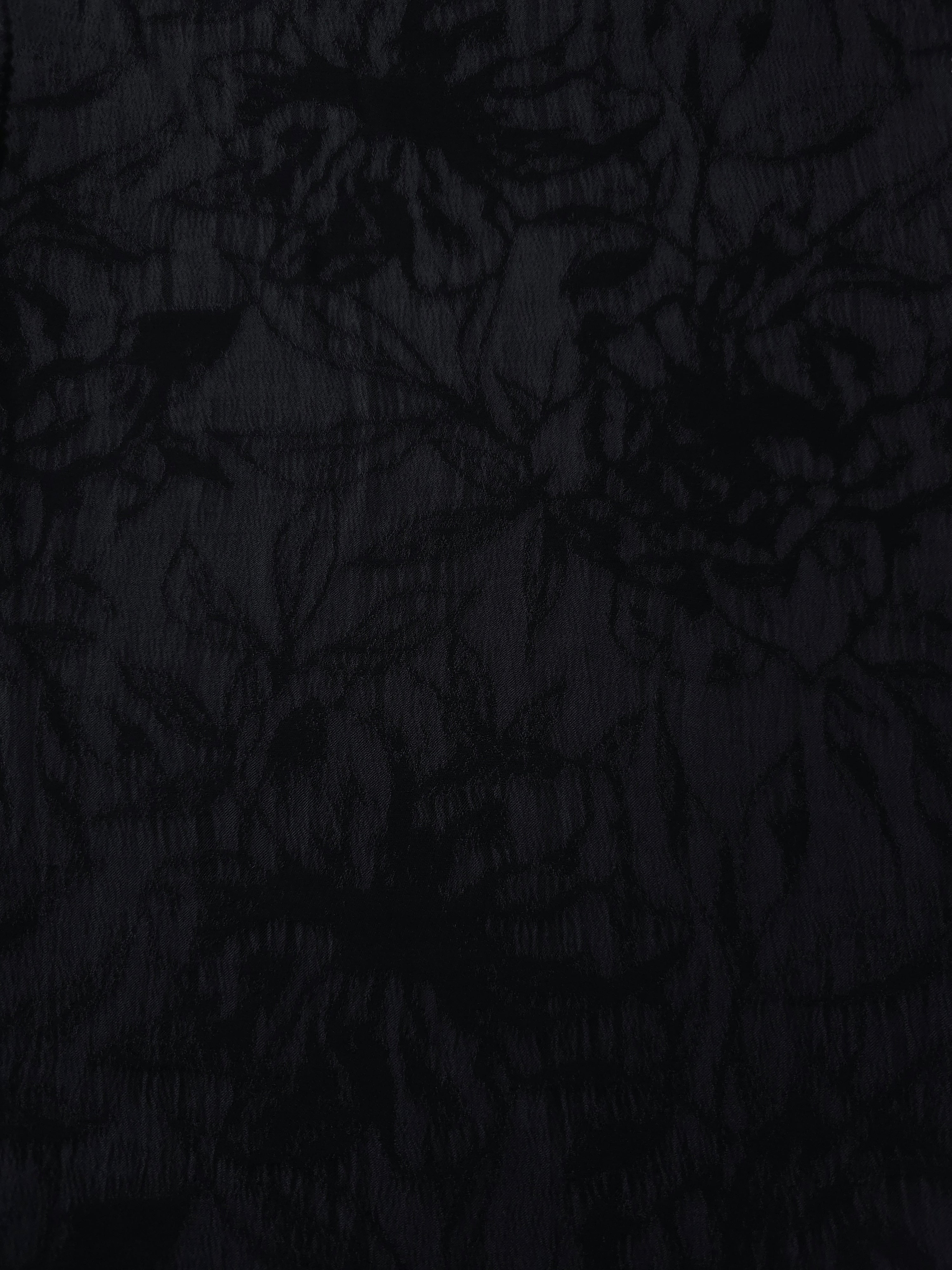 Black dense floral vine lyocell viscose jacquard with tonal bloom texture for dresses.