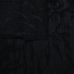 Selvage detail of black dense floral vine lyocell viscose jacquard fabric.