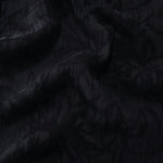 Draped black floral vine jacquard showing elegant texture for blouses and skirts.
