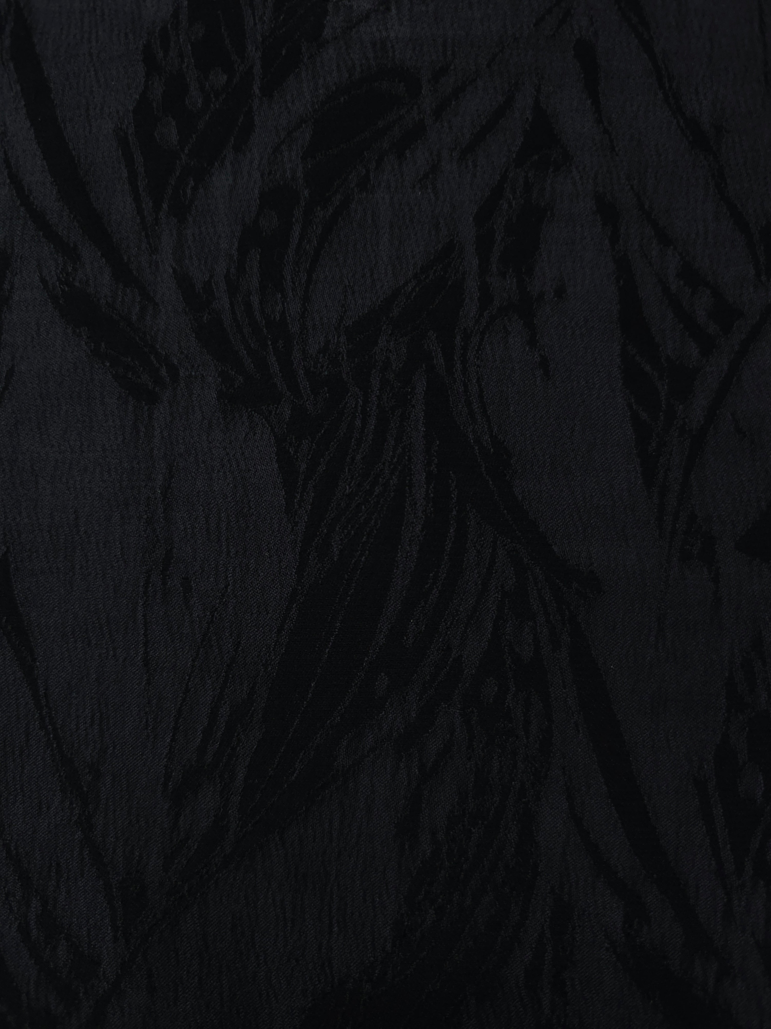 Black large leaf lyocell viscose jacquard with tonal woven pattern for dresses.