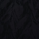 Close texture of black large leaf jacquard showing raised lyocell viscose detail.
