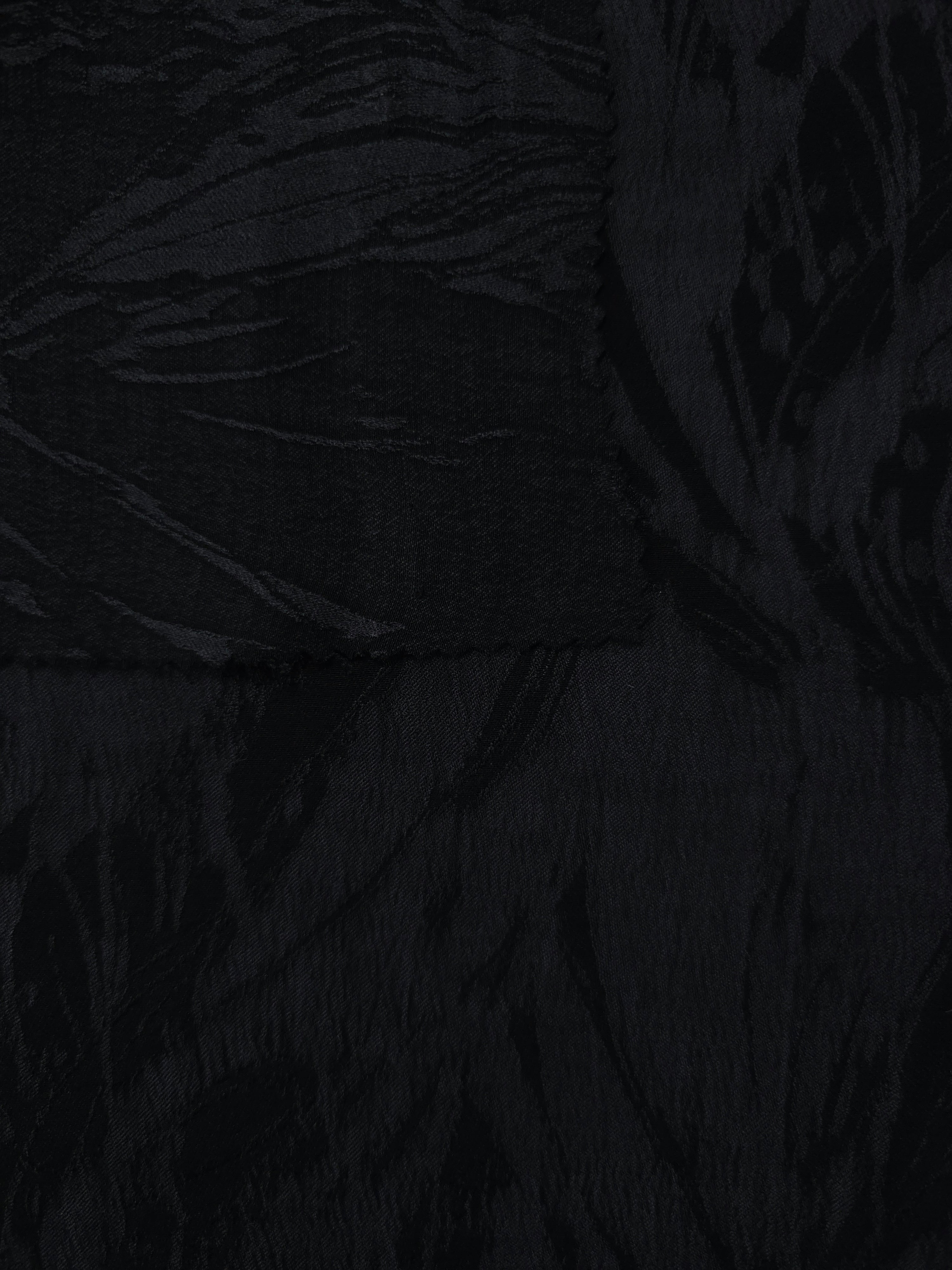 Selvage detail of black large leaf lyocell viscose jacquard for cutting reference.