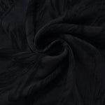 Swirl drape of black large leaf jacquard with dark-on-black tonal contrast.