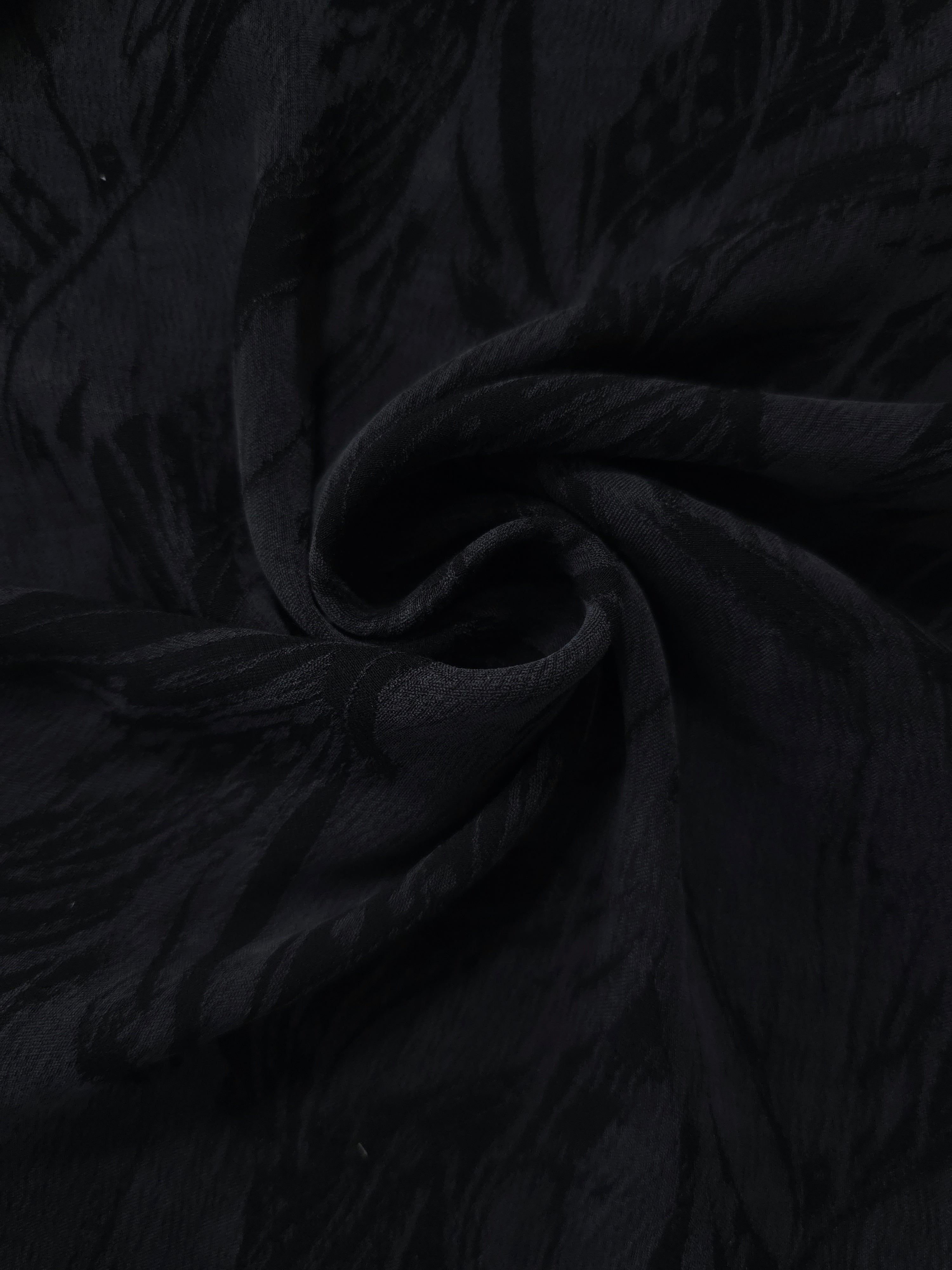 Swirl drape of black large leaf jacquard with dark-on-black tonal contrast.
