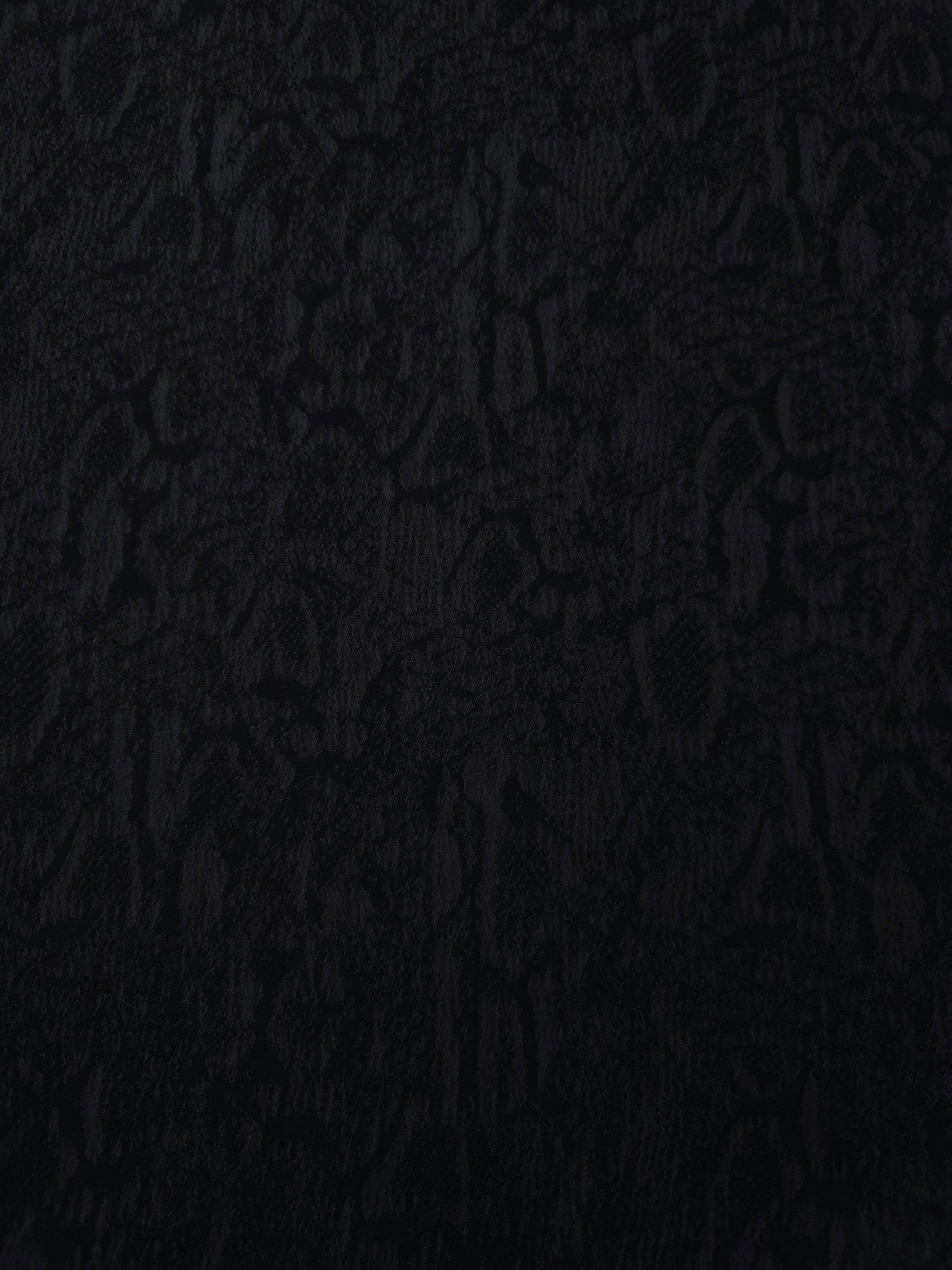 Black ornamental floral lyocell viscose jacquard with tonal pattern for dressmaking.