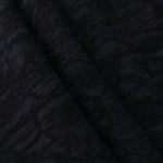 Folded black ornamental floral lyocell viscose jacquard for skirts and jackets.