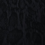 Close texture of black paisley vine jacquard showing darker raised surface detail.