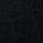 Selvage detail of black paisley vine lyocell viscose jacquard fabric.