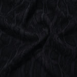Draped black paisley vine jacquard showing fluid texture for blouses and skirts.