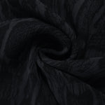 Swirl drape of black paisley vine jacquard with tonal lyocell viscose sheen.