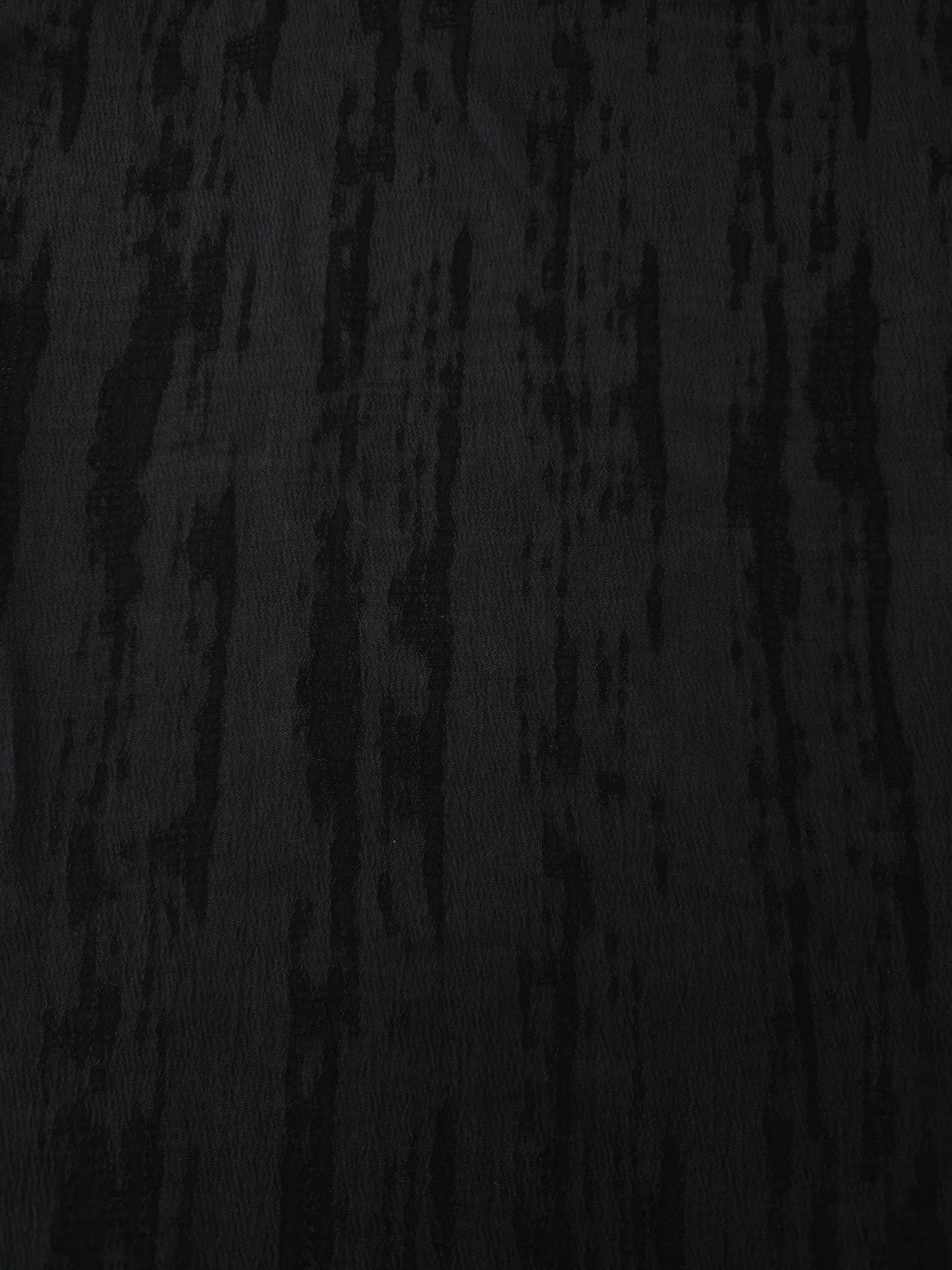 Black lyocell viscose jacquard with vertical bark stripe texture for structured dresses.
