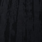 Close texture of tonal black bark stripe jacquard in lyocell viscose for fashion sewing.