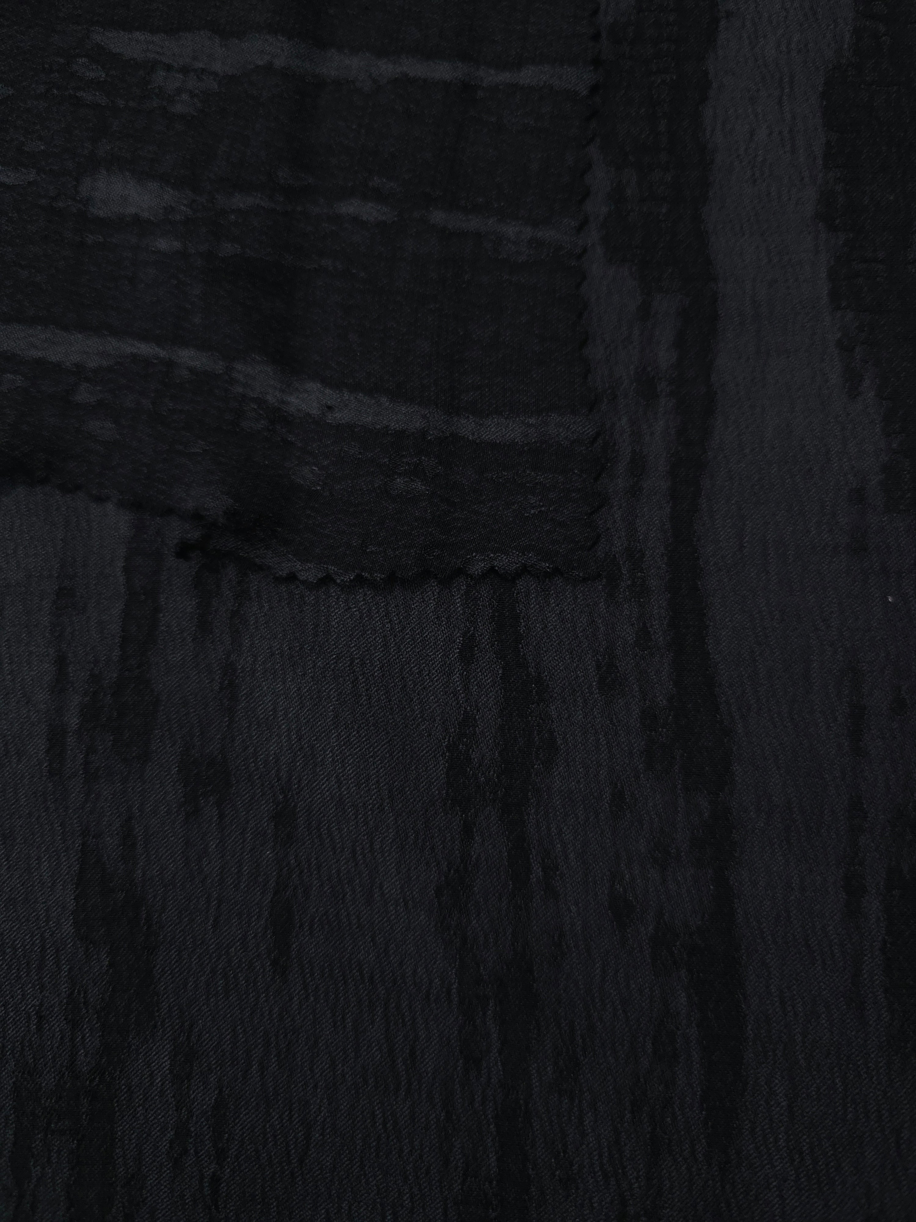 Selvage detail of black vertical stripe jacquard showing tonal lyocell viscose weave.