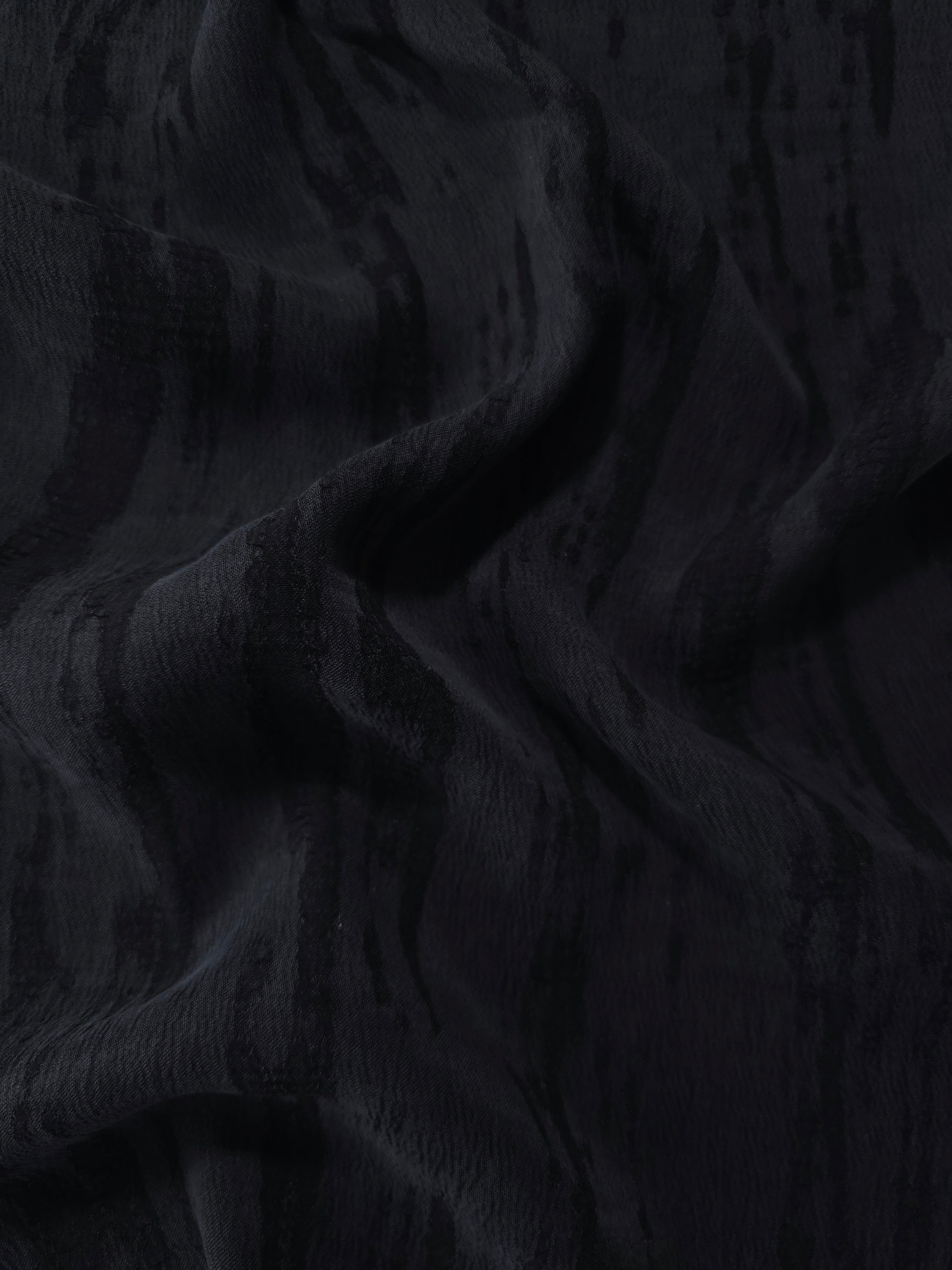 Draped black bark stripe lyocell viscose jacquard showing firm flow for jackets and dresses.