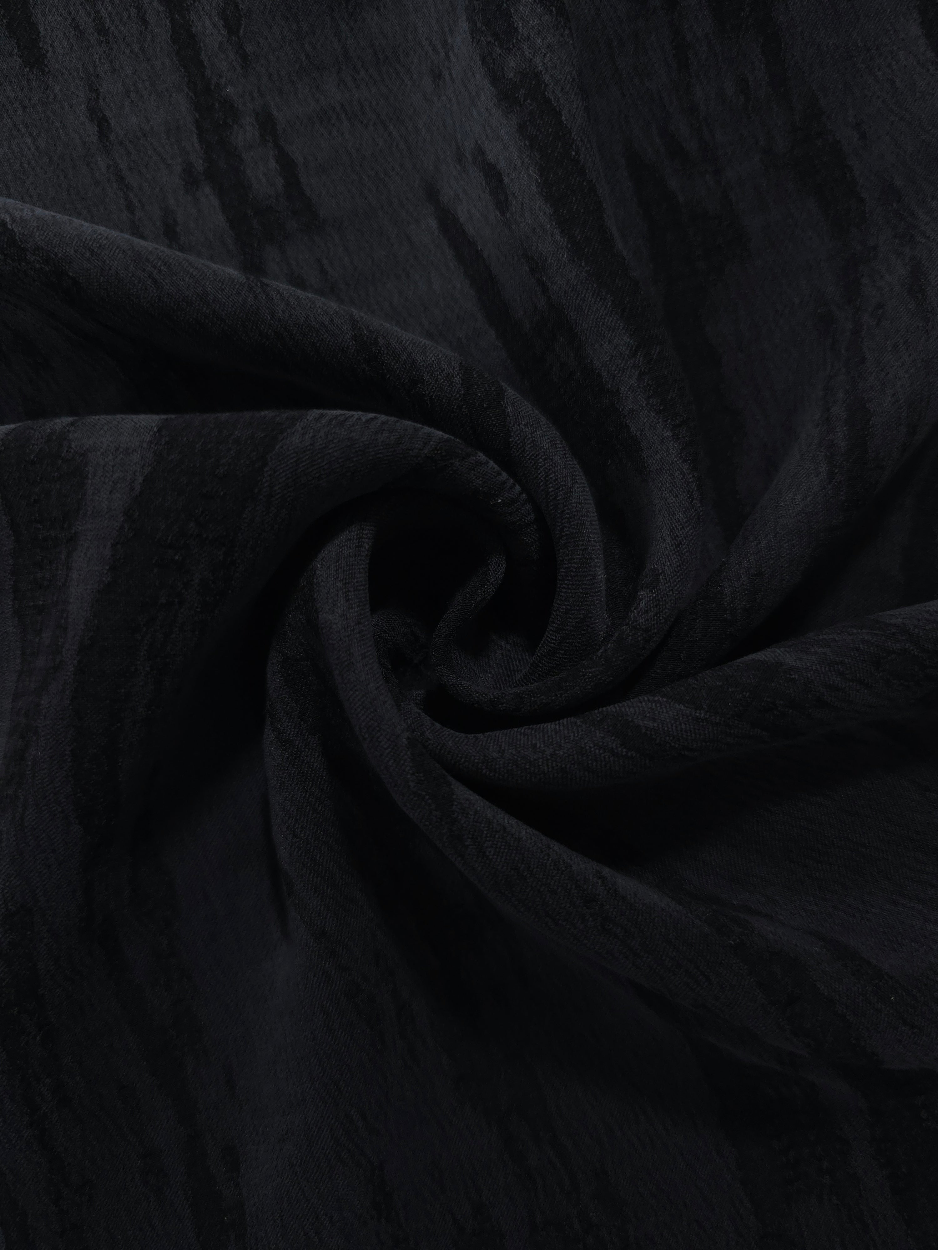 Swirl drape of black bark stripe lyocell viscose jacquard with darker woven contrast.