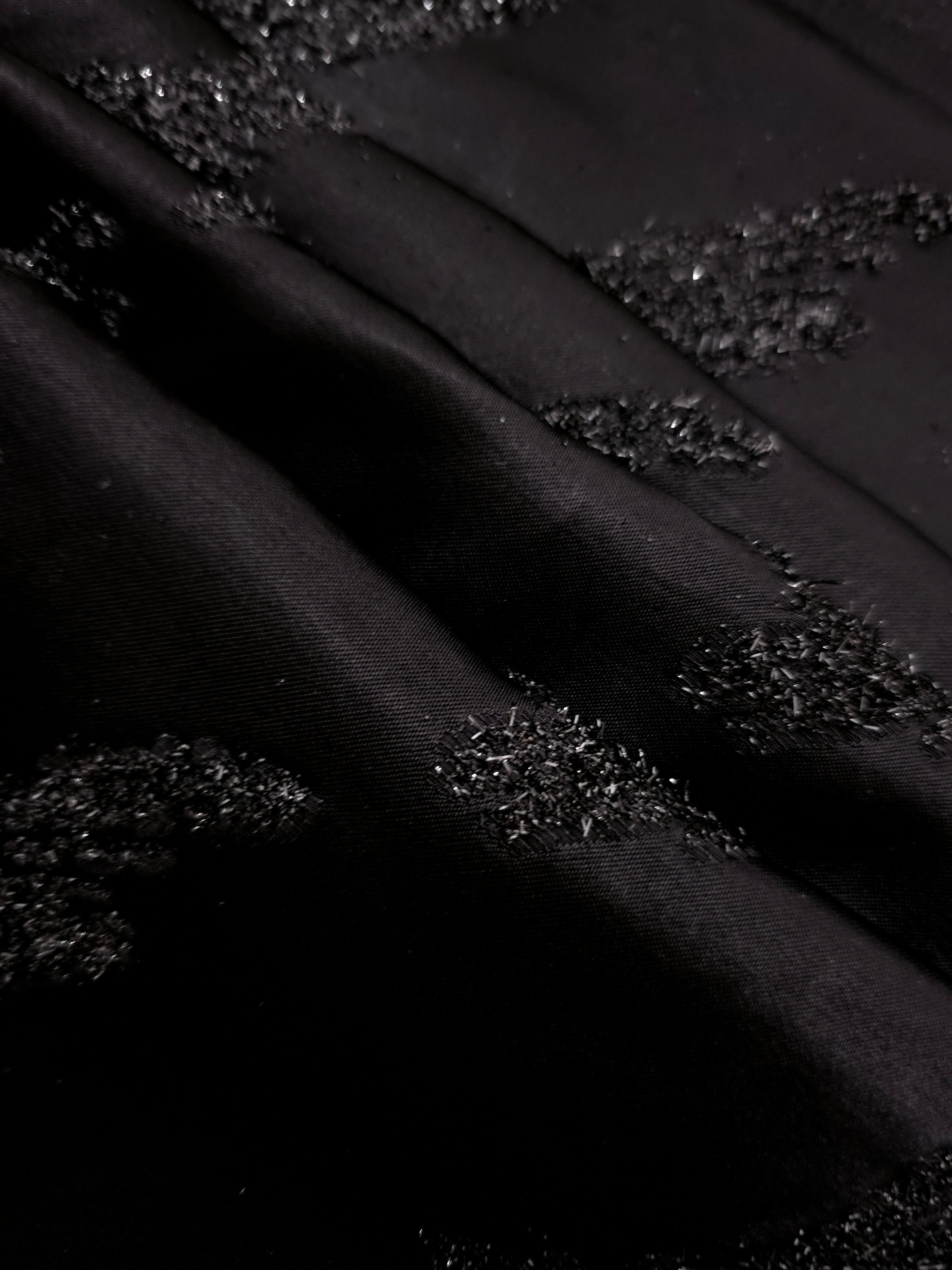 Detail view of Metallic Black viscose metallic jacquard with painterly art strokes