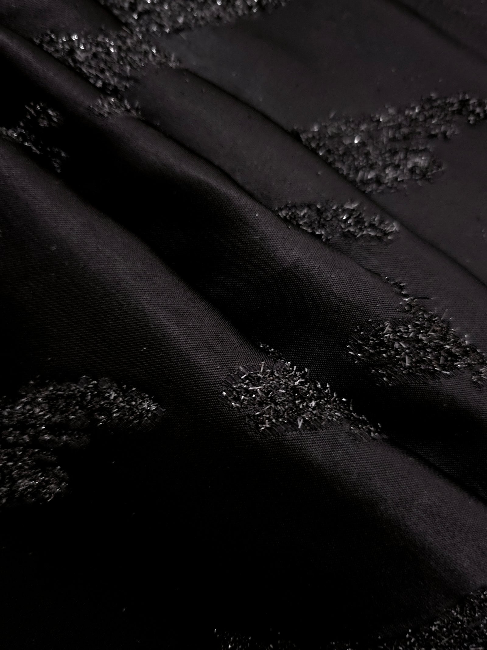 Detail view of Metallic Black viscose metallic jacquard with painterly art strokes