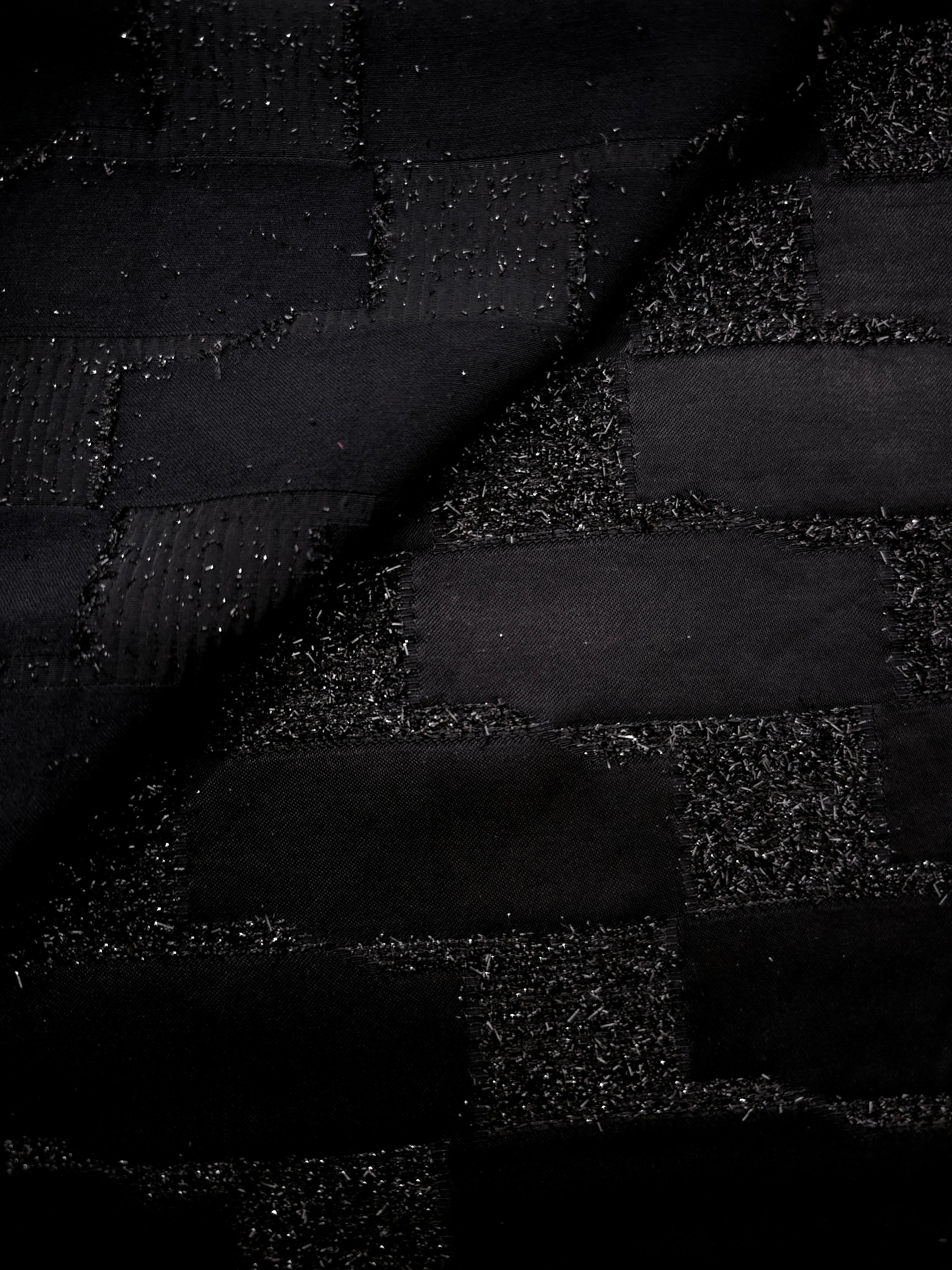 Close-up of Metallic Black viscose jacquard with embossed crosshatch basket weave