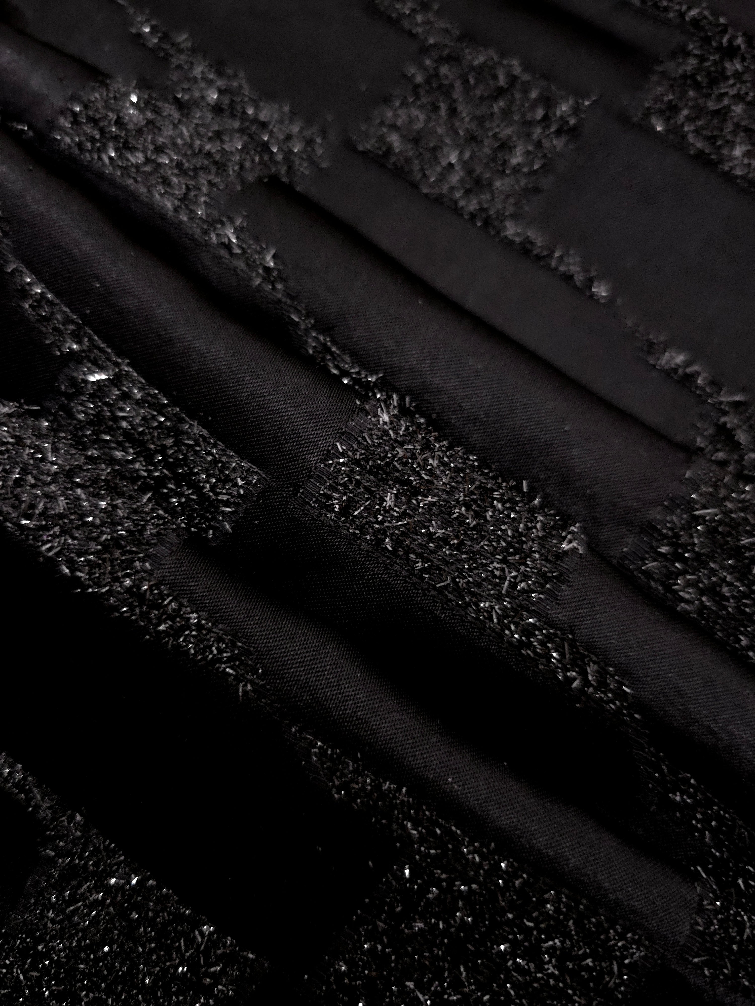 Detail view of Metallic Black viscose metallic jacquard with interlaced grid texture