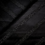 Close-up of Metallic Black viscose jacquard with embossed linear pinstripes