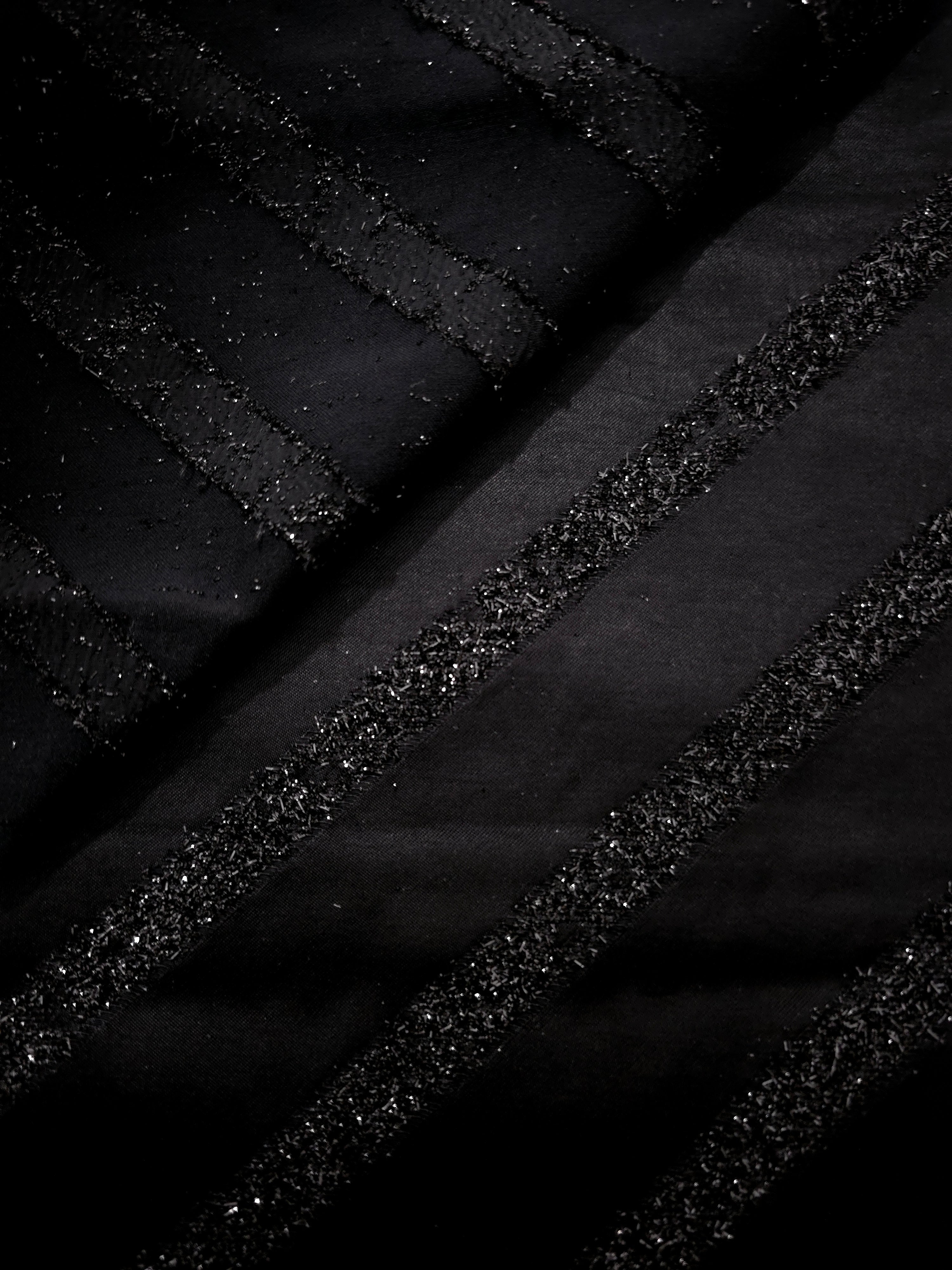Close-up of Metallic Black viscose jacquard with embossed linear pinstripes
