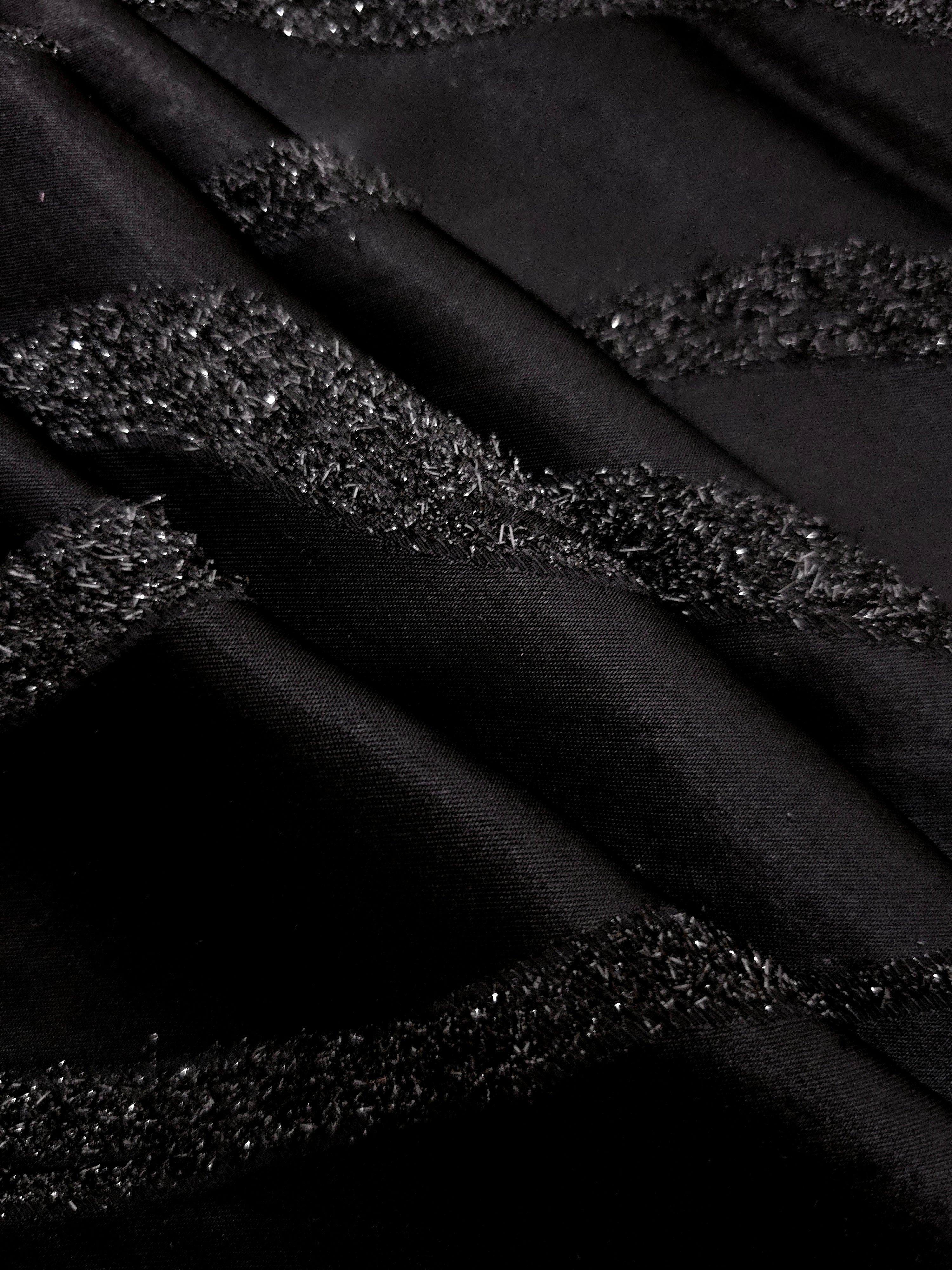 Detail view of Metallic Black viscose metallic jacquard with sinuous wave lines