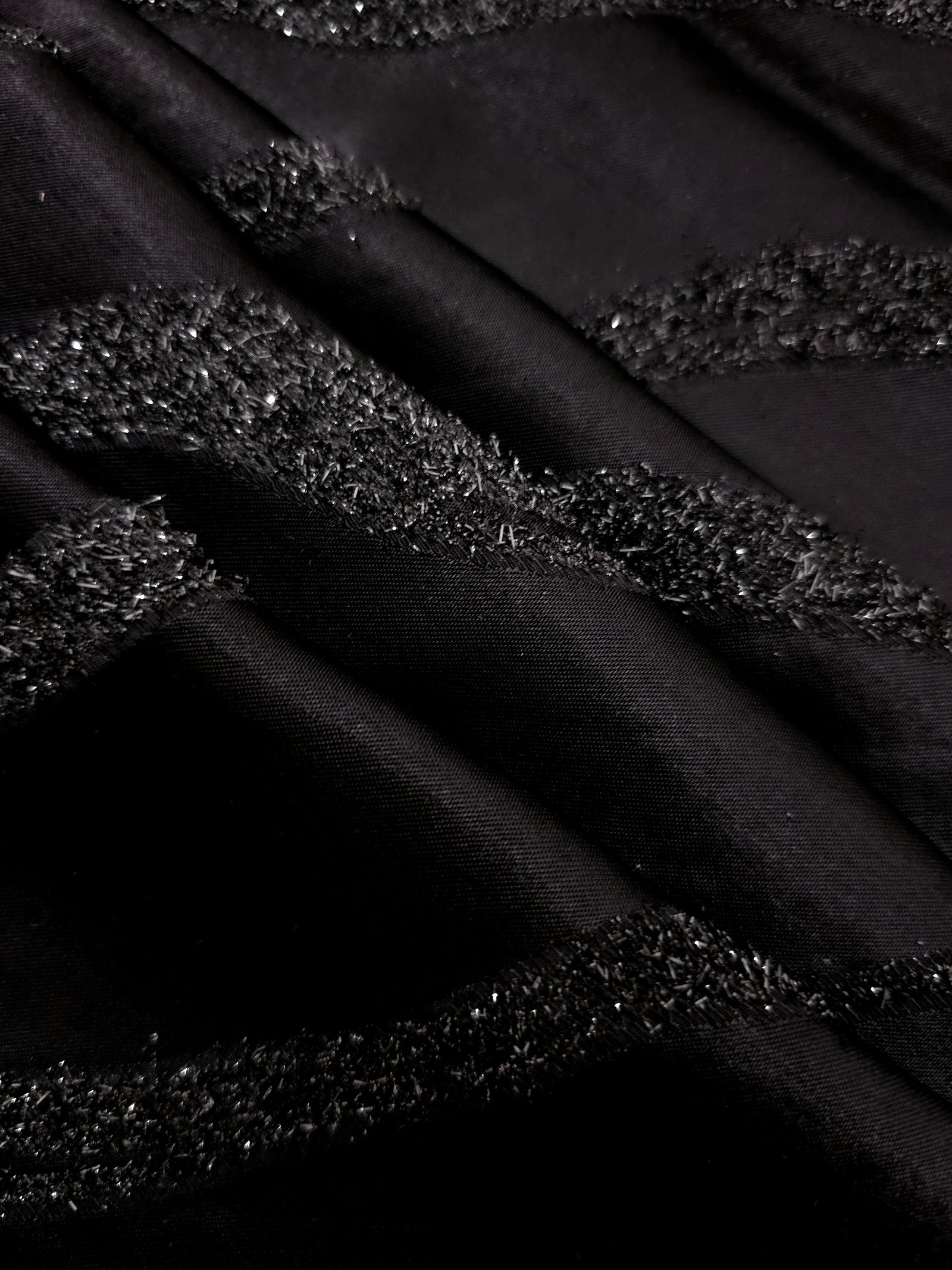Detail view of Metallic Black viscose metallic jacquard with sinuous wave lines