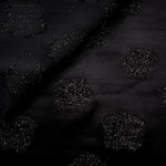 Close-up of Metallic Black viscose jacquard with embossed stone dot pattern