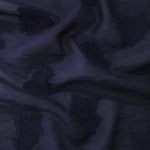 Pattern detail of dark blue big leaf embossed viscose jacquard fabric for layered dresses.