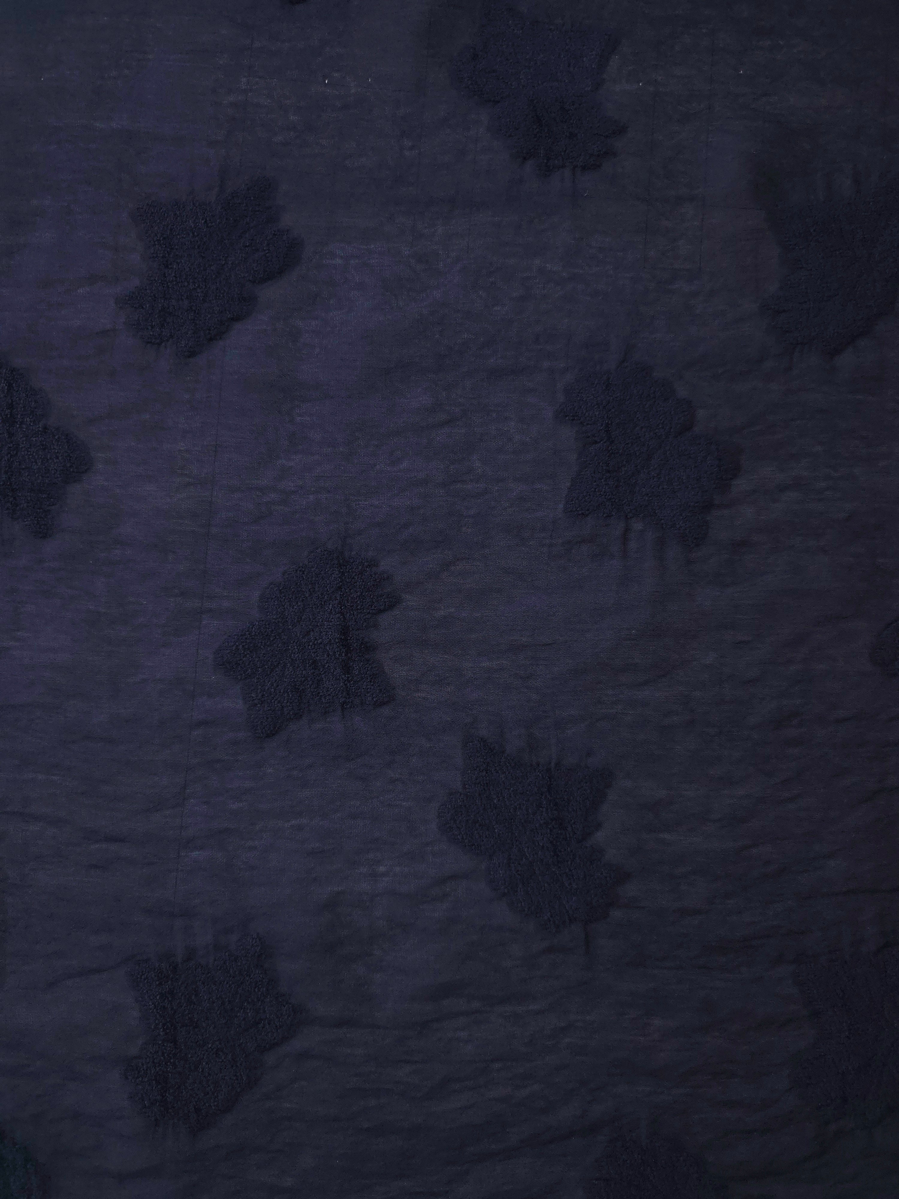 Soft drape of dark blue big leaf embossed viscose jacquard fabric for sheer garment layers.