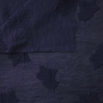 Wide view of dark blue big leaf embossed viscose jacquard fabric with raised motif.