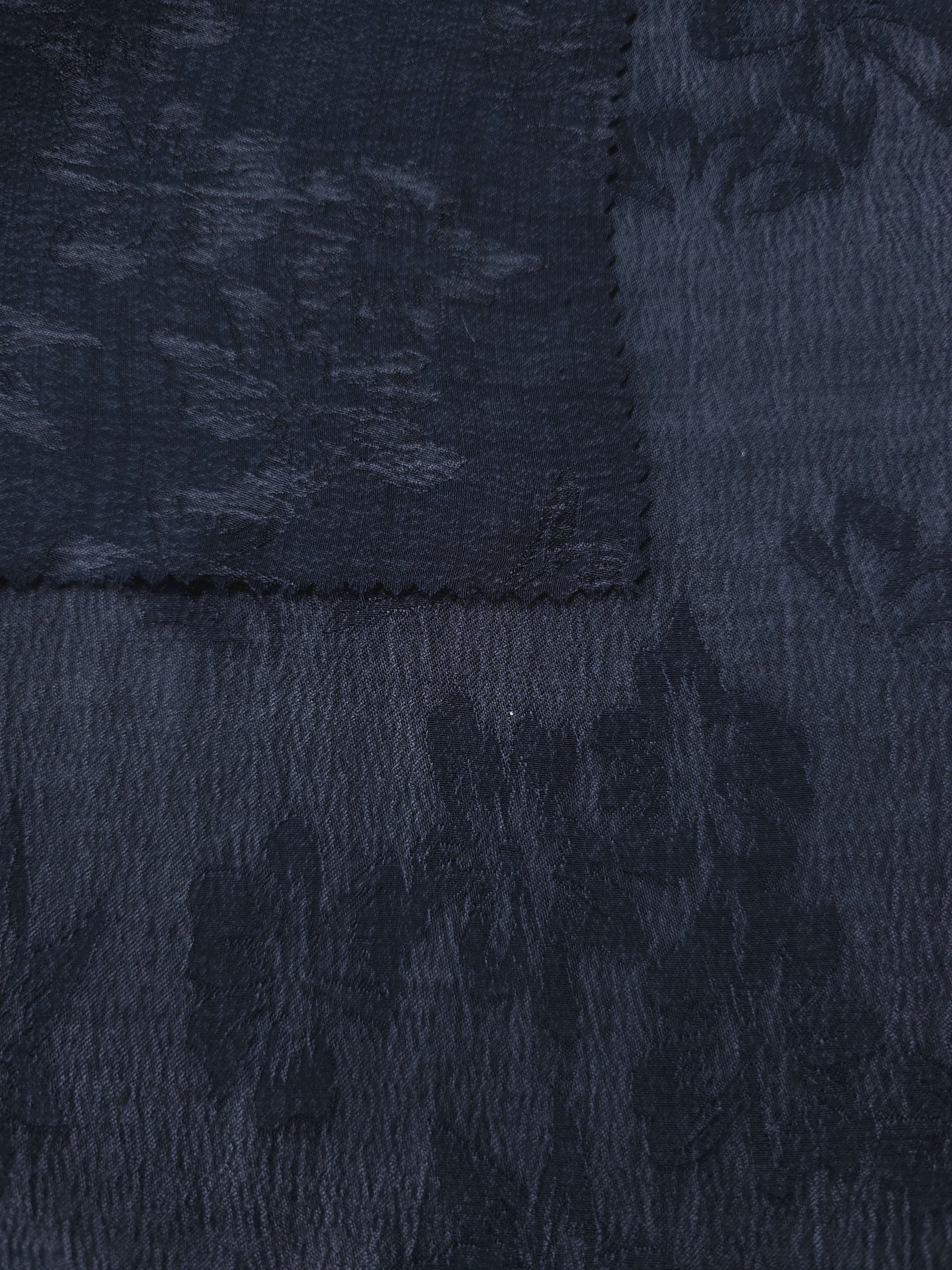Selvage view of blue lyocell viscose jacquard with floral texture for dresses and jackets.