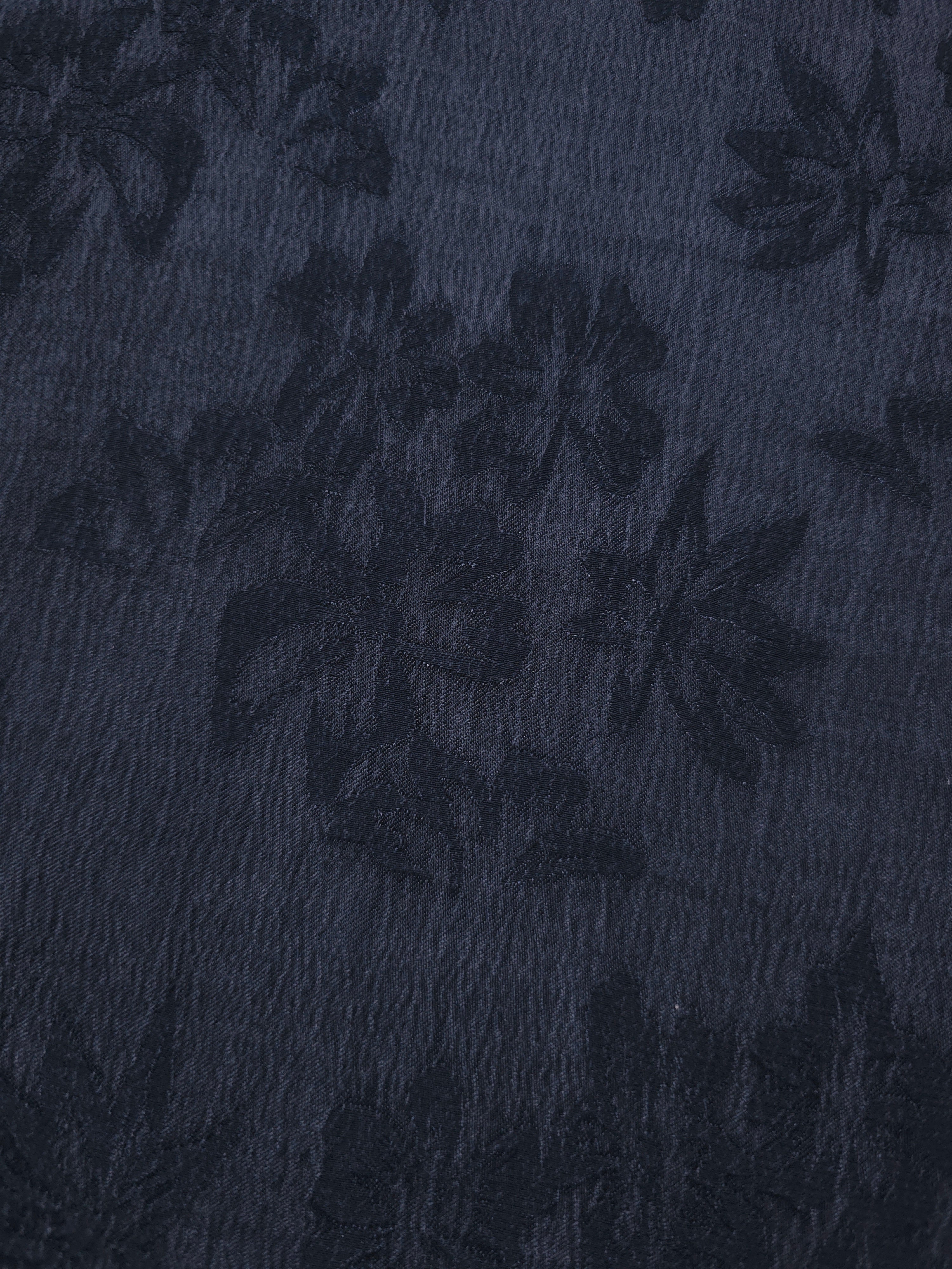 Blue botanical floral lyocell viscose jacquard showing woven pattern for occasion dress fabric.