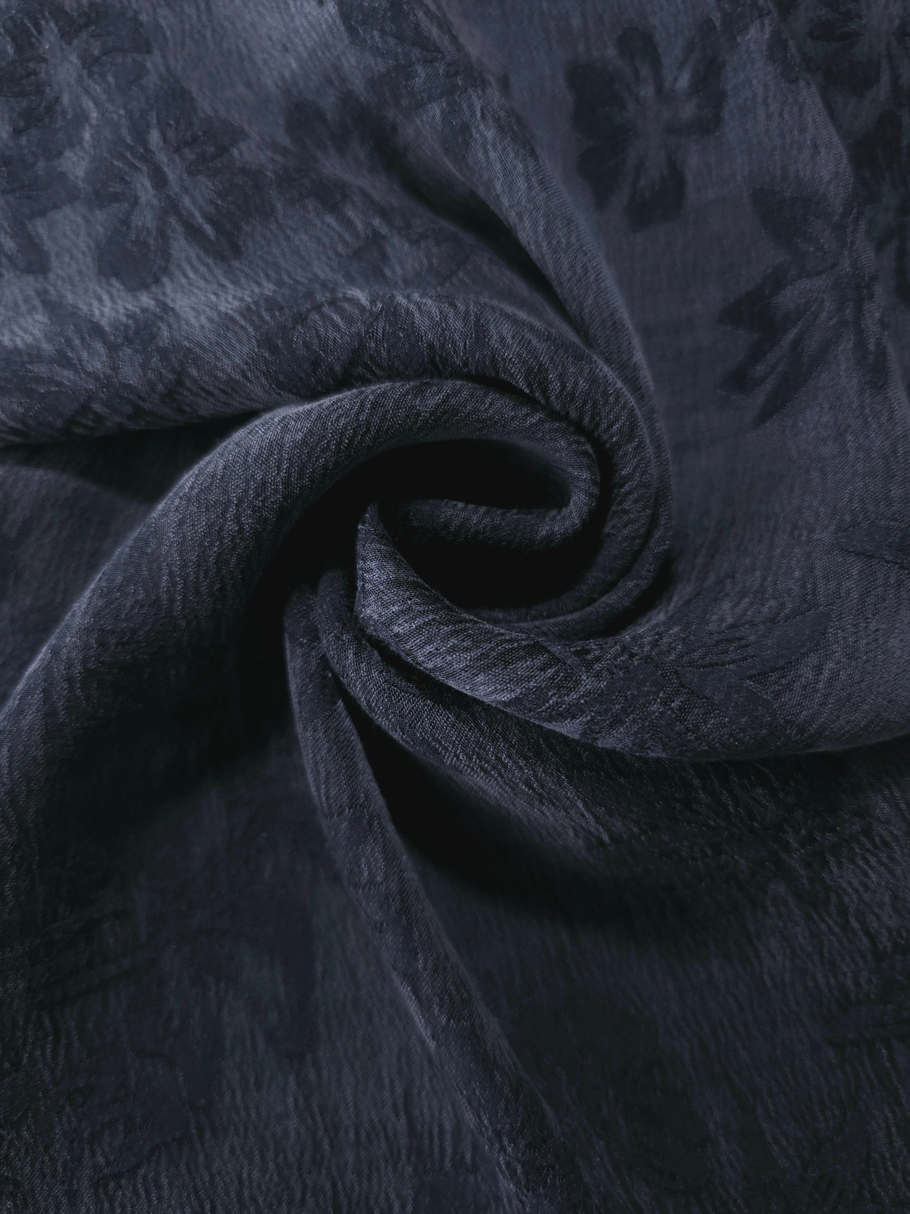 Blue lyocell viscose jacquard in a swirl drape showing botanical floral movement.