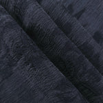 Folded blue botanical floral jacquard in lyocell viscose for tailored dress and skirt layers.