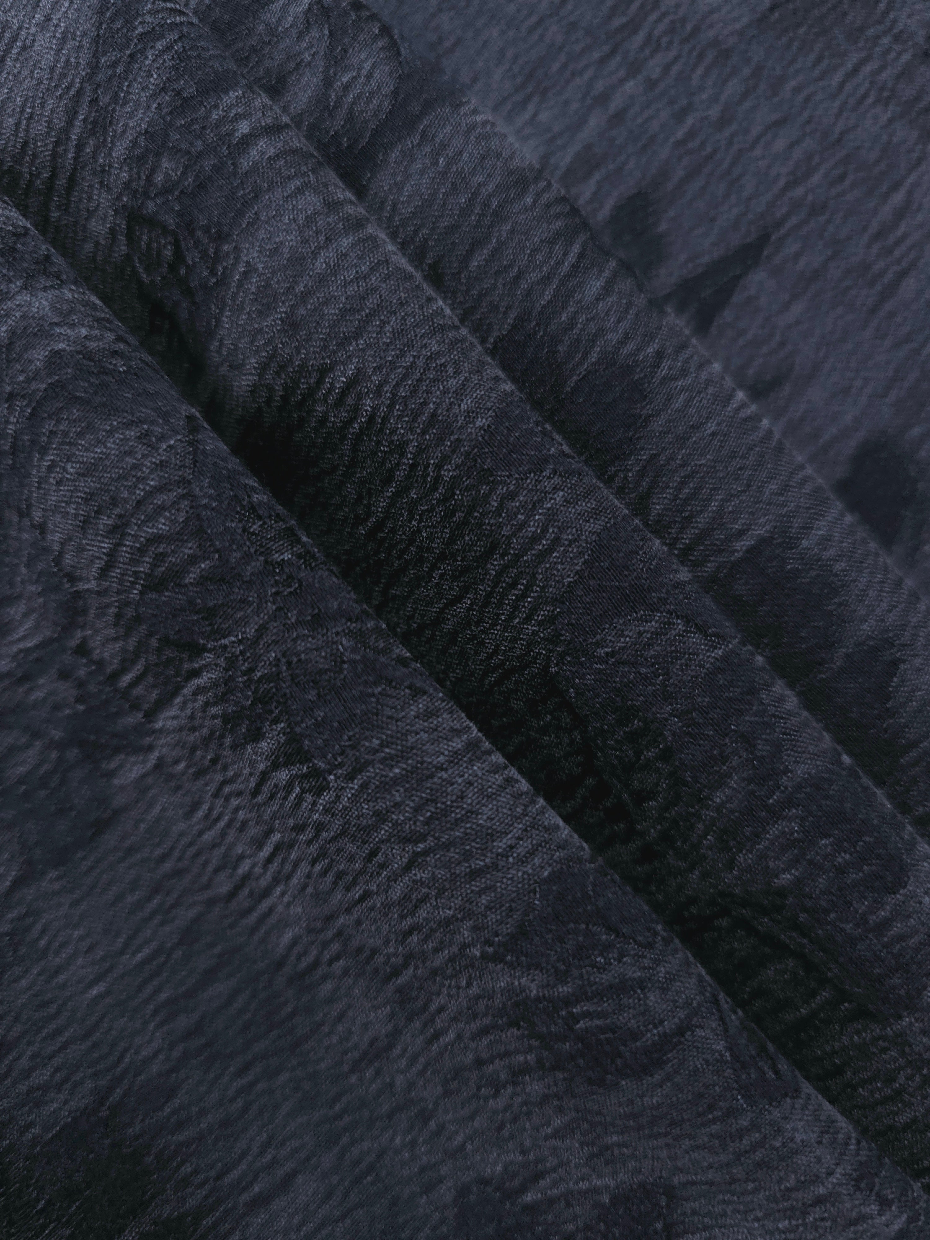 Folded blue botanical floral jacquard in lyocell viscose for tailored dress and skirt layers.