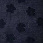 Wide view of dark blue flower embossed viscose jacquard fabric with tonal raised texture.