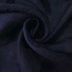 Drape view of dark blue leaf embossed viscose jacquard fabric for kaftan layers.