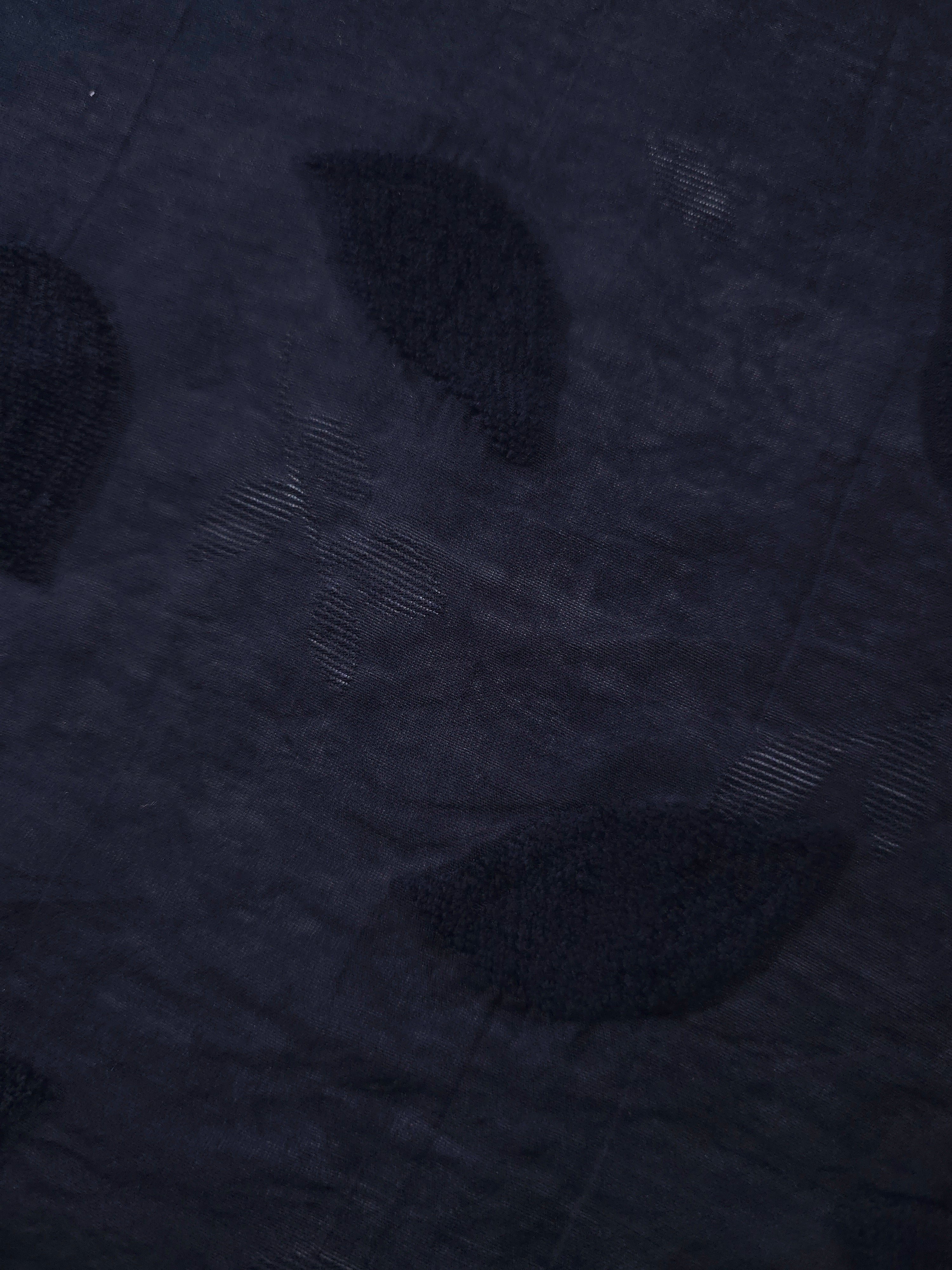 Drape view of dark blue leaf embossed viscose jacquard fabric for layered dresses.