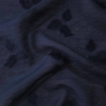 Pattern detail of dark blue small leaf embossed viscose jacquard fabric.