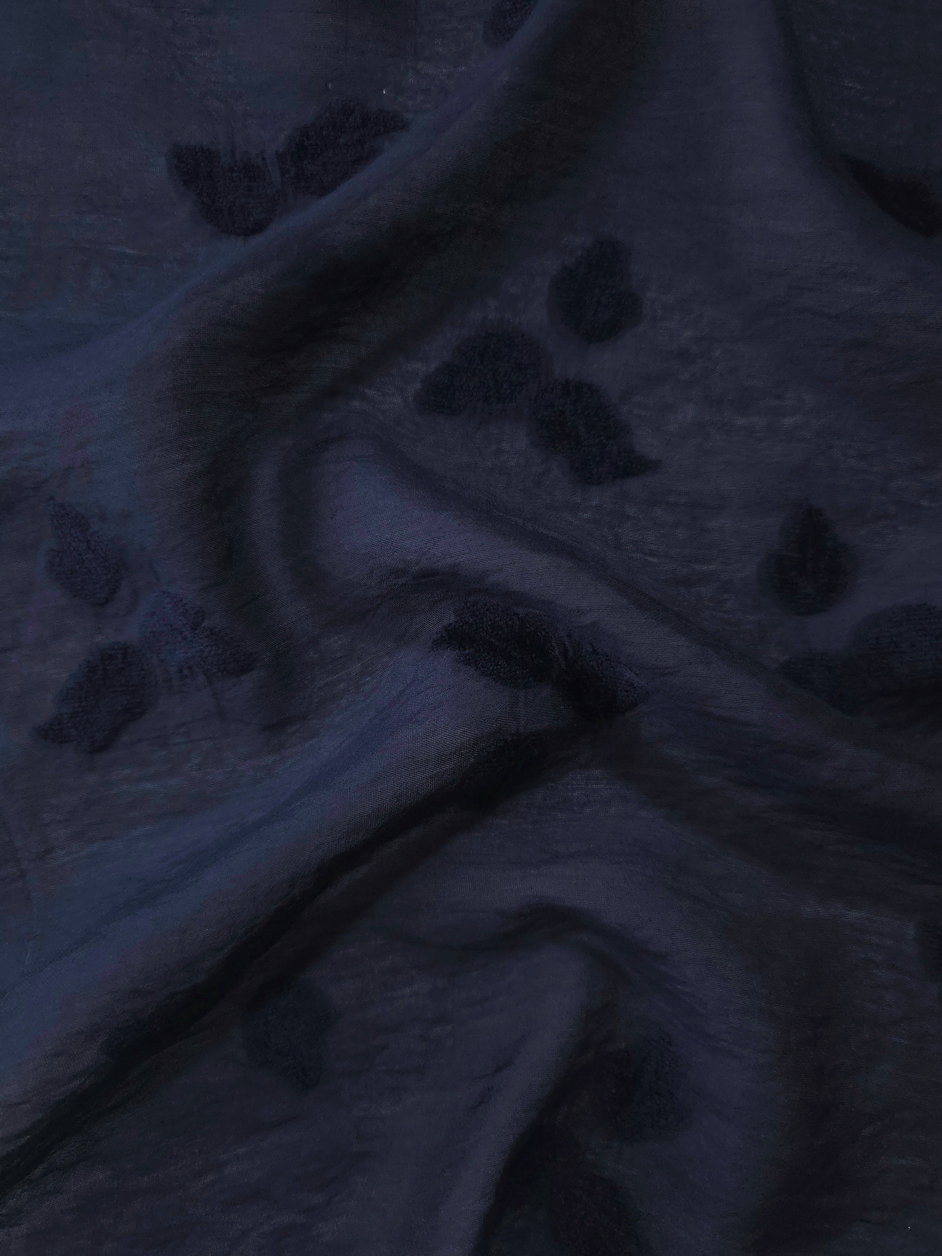 Pattern detail of dark blue small leaf embossed viscose jacquard fabric.