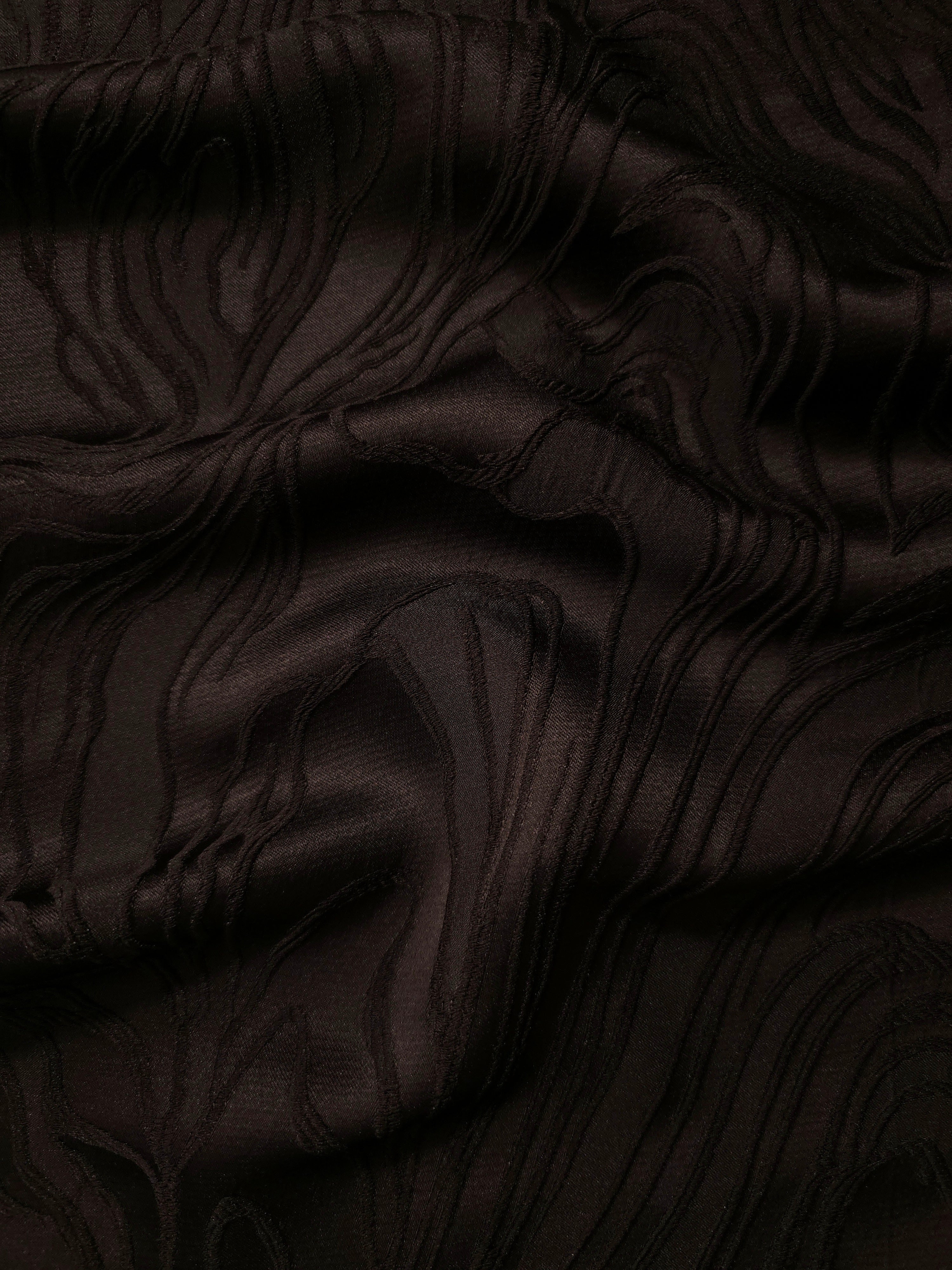 Brown branch polyester crepe jacquard fabric in a textured drape for dresses and tailored layers.