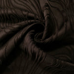 Wide view of brown branch polyester crepe jacquard fabric for skirts and structured layers.