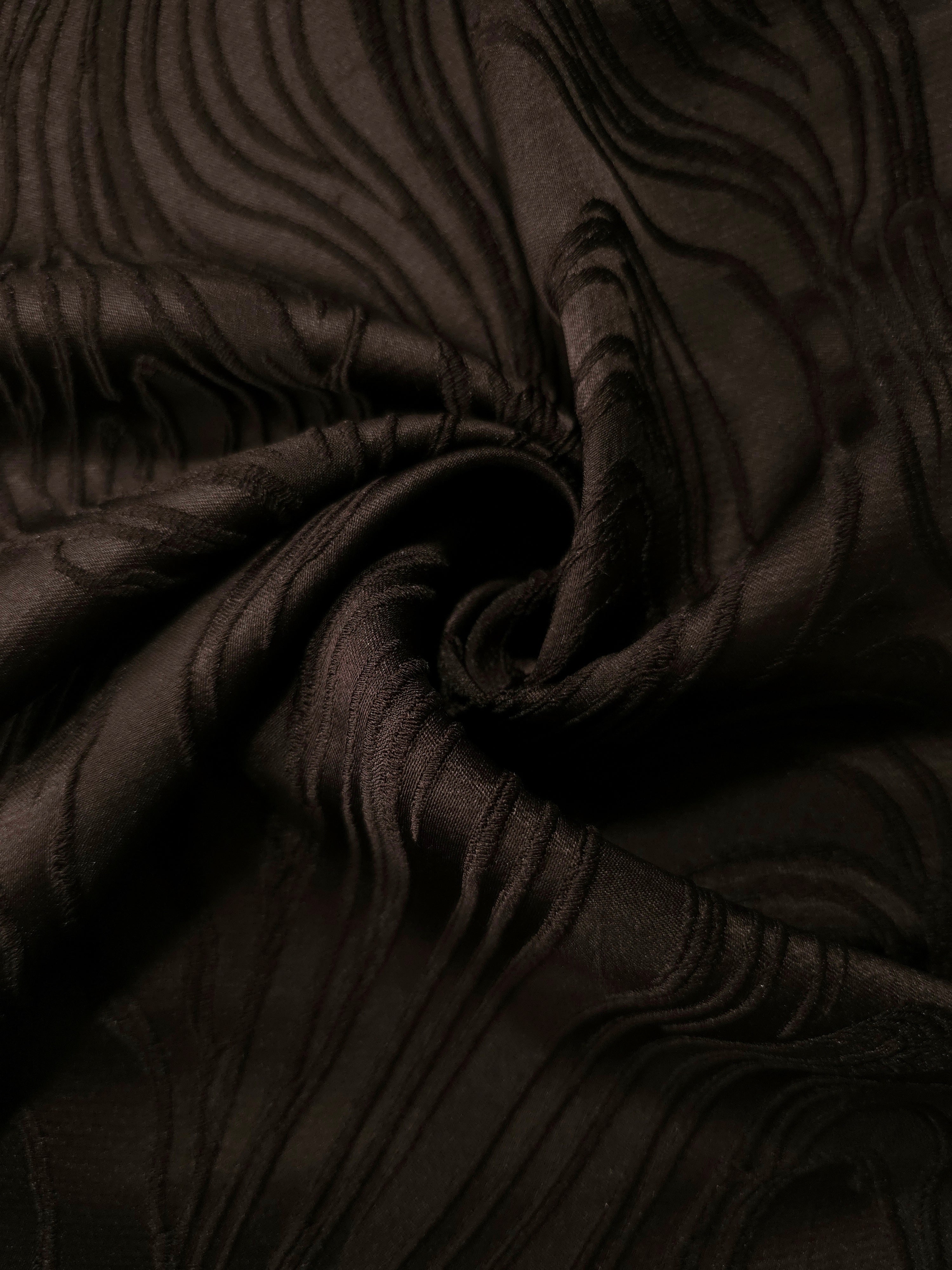 Wide view of brown branch polyester crepe jacquard fabric for skirts and structured layers.
