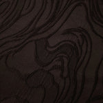 Drape view of brown branch polyester crepe jacquard fabric for dresses, skirts and jackets.
