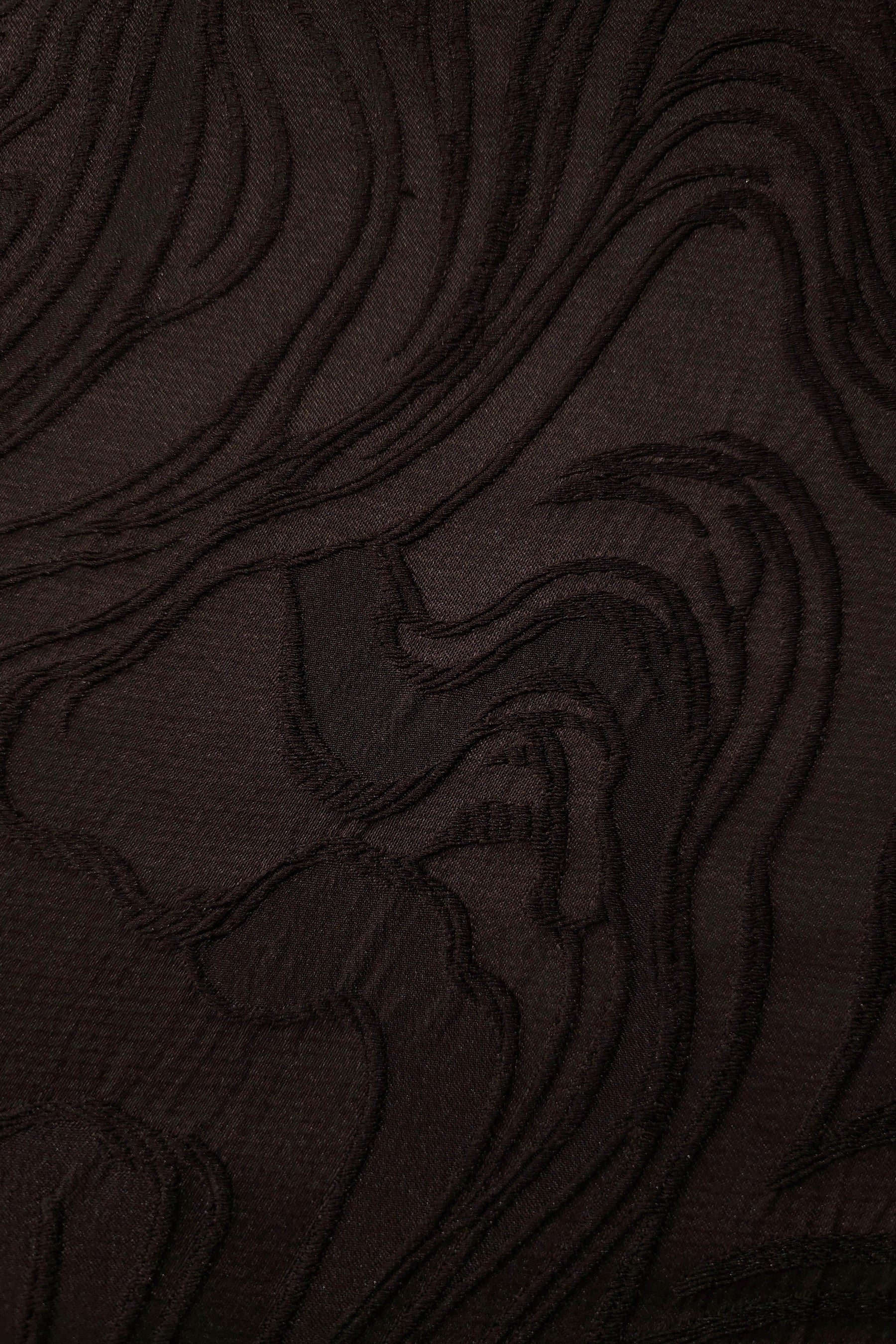 Drape view of brown branch polyester crepe jacquard fabric for dresses, skirts and jackets.