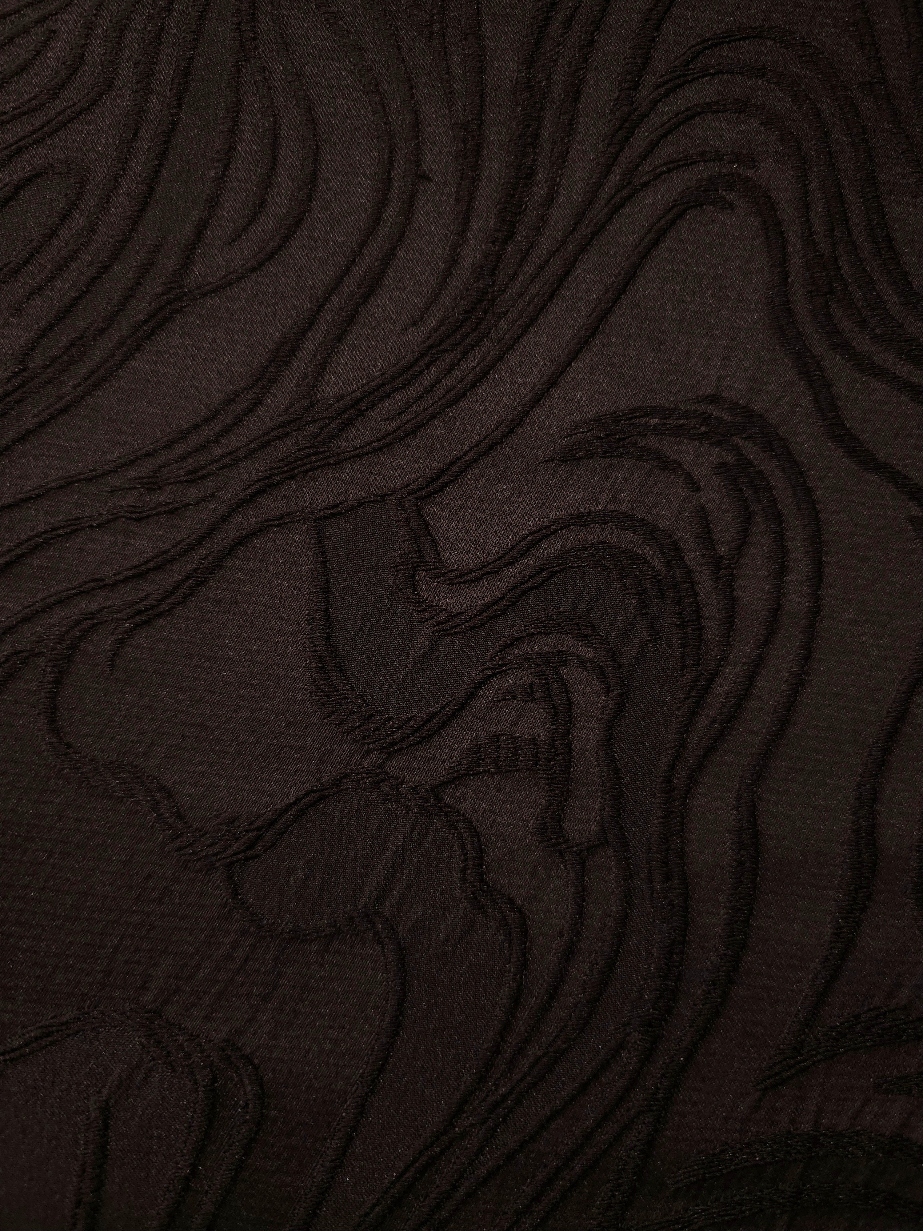 Drape view of brown branch polyester crepe jacquard fabric for dresses, skirts and jackets.