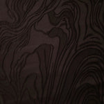 Full view of brown branch polyester crepe jacquard fabric with raised woven texture.